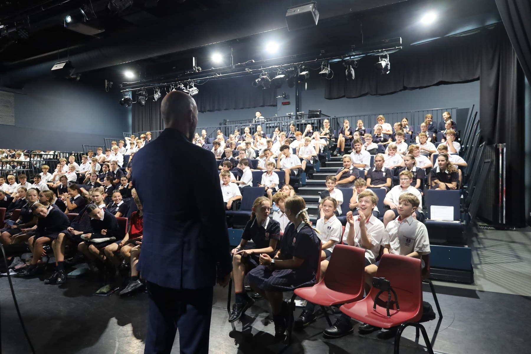 Nick Kenny presenting to a full cohort of students in a school hall