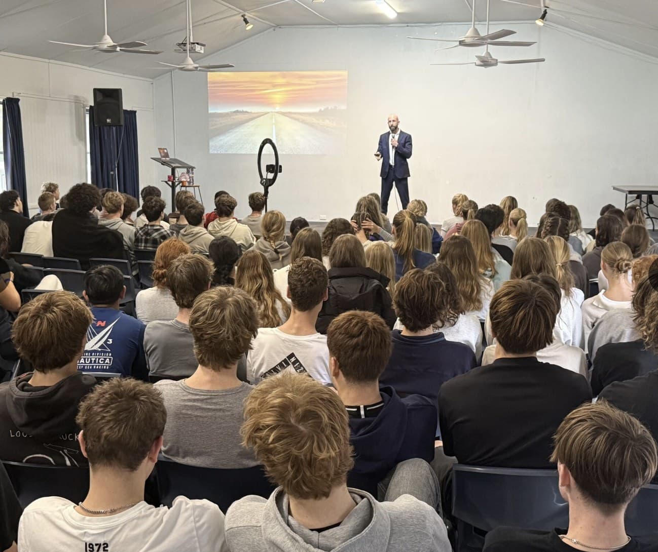 Nick Kenny presenting to a full cohort of secondary students in a school hall